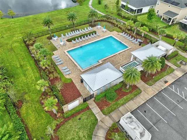 a kitchen with a sink a center island stainless steel appliances and cabinets