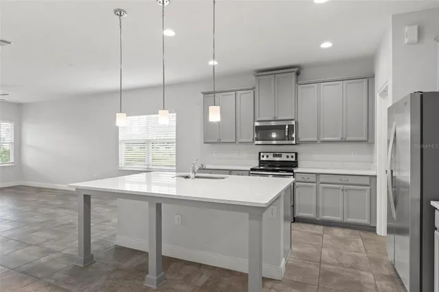 a view of a kitchen with furniture and a ceiling fan
