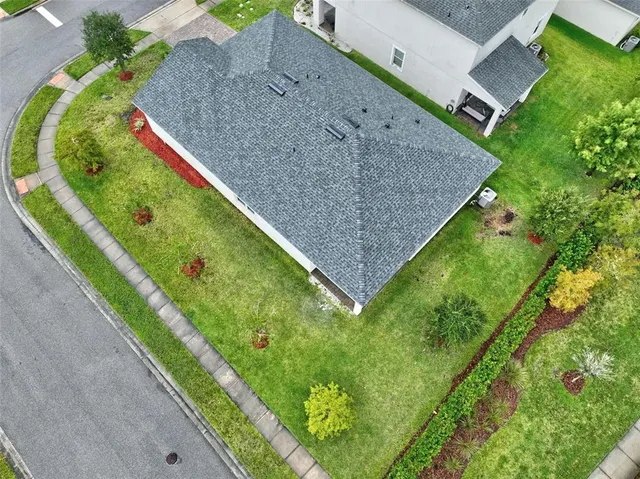 an aerial view of a house with outdoor space and lake view
