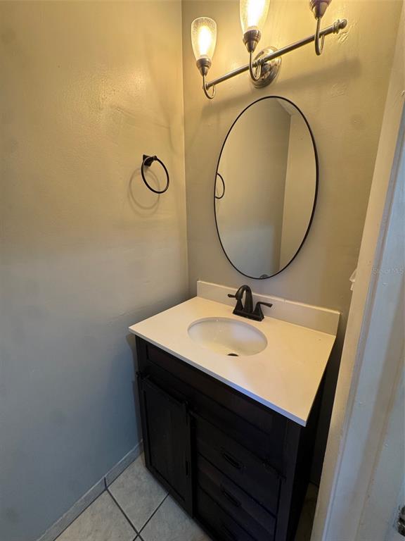 4411 Southwest 34th Street, Unit 1001 Gainesville, FL 32608 - Photo 14 of 20 a bathroom with a sink vanity and a mirror