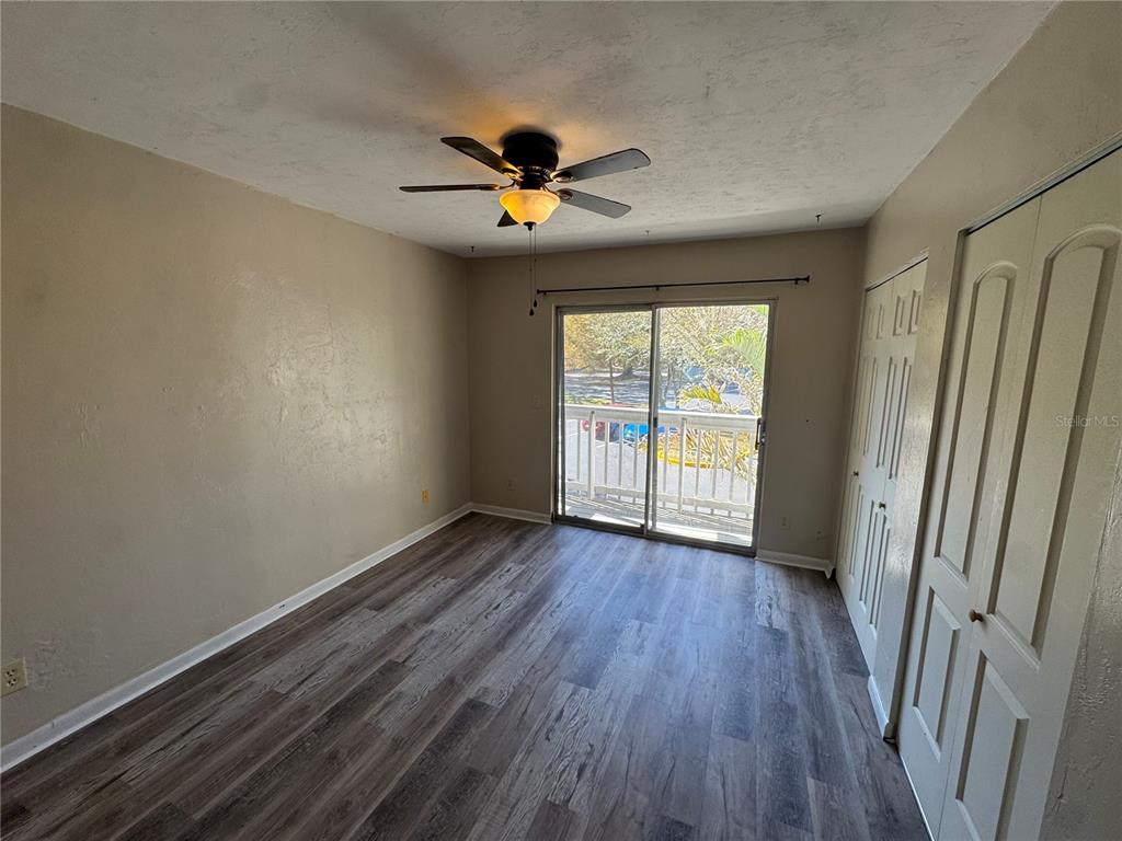 4411 Southwest 34th Street, Unit 1001 Gainesville, FL 32608 - Photo 17 of 20 a view of an empty room with wooden floor and a window