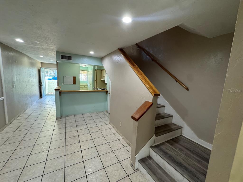4411 Southwest 34th Street, Unit 1001 Gainesville, FL 32608 - Photo 10 of 20 a view of kitchen with furniture and staircase
