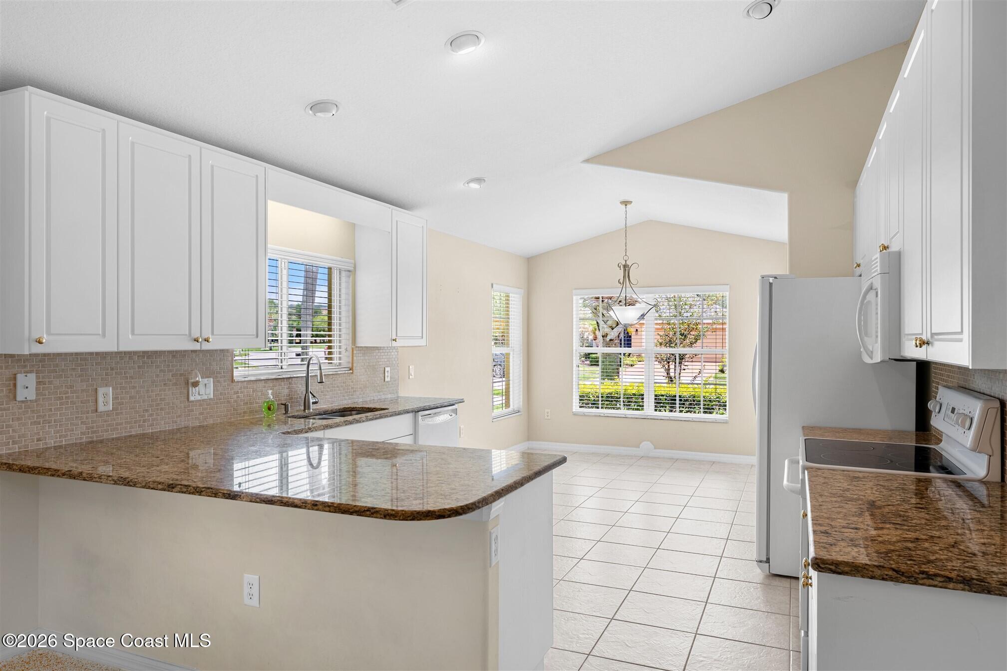 6904 Renshaw Drive Melbourne, FL 32940 - Photo 5 of 46 a kitchen with stainless steel appliances granite countertop a sink a stove and a granite counter tops