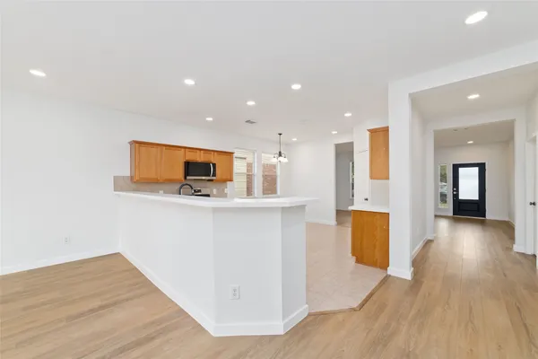 a view of kitchen with cabinets and wooden floor