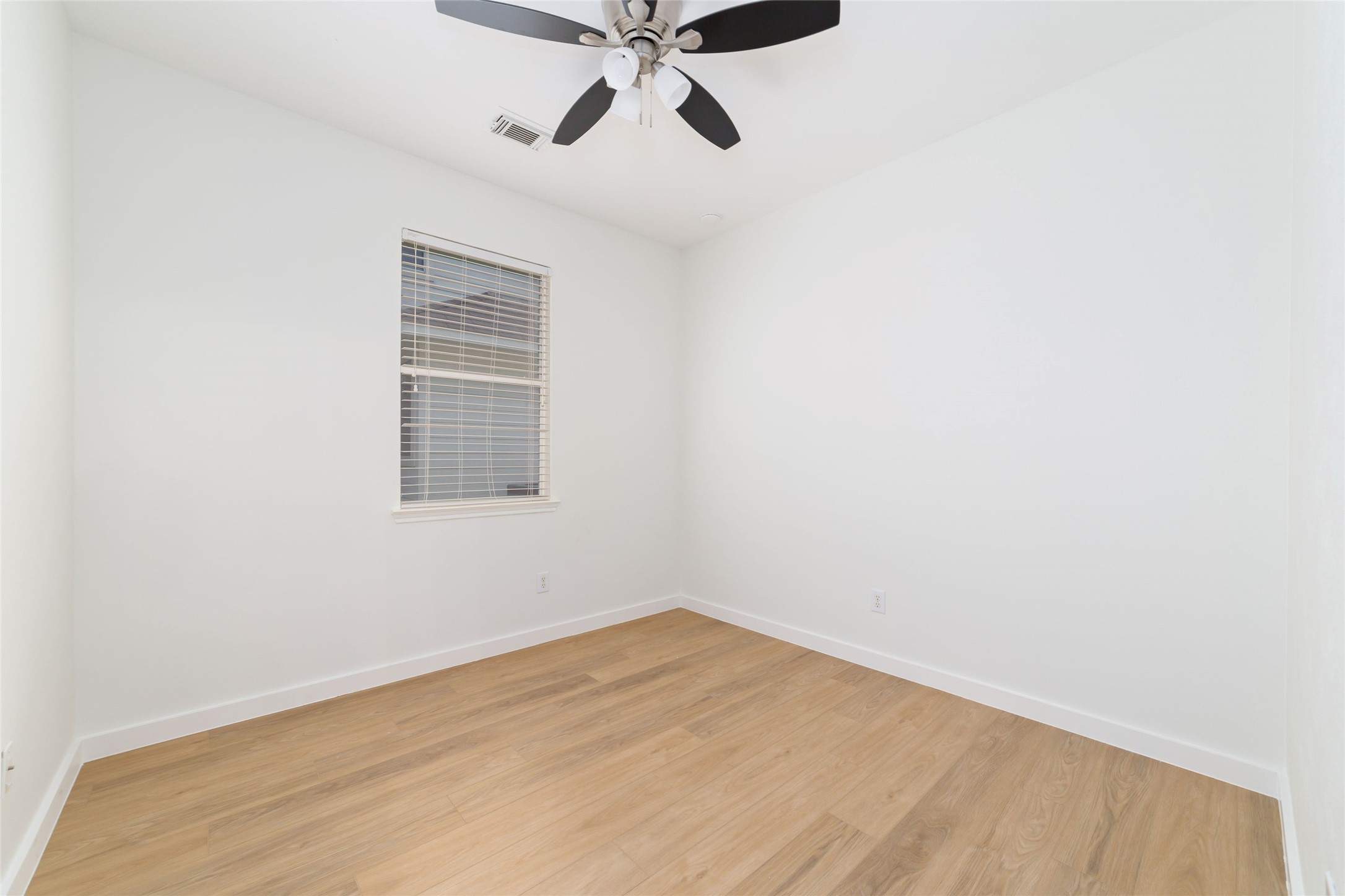 20215 Enchanted Rose Cypress, TX 77433 - Photo 14 of 24 an empty room with a window and a ceiling fan