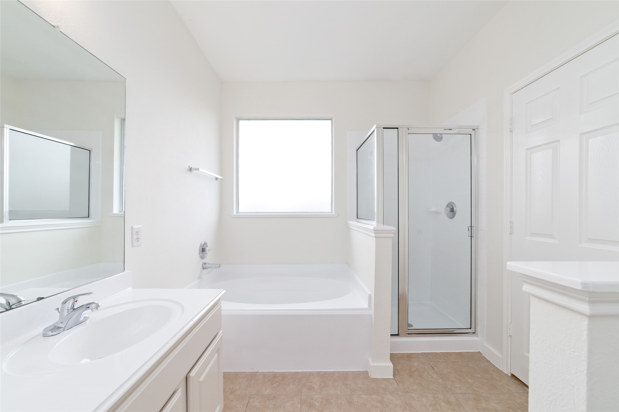 20215 Enchanted Rose Cypress, TX 77433 - Photo 19 of 24 a bathroom with a tub sink vanity and a mirror