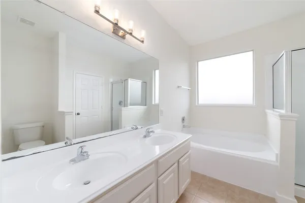 a bathroom with a bathtub and a sink