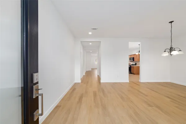 a view of a room with wooden floor
