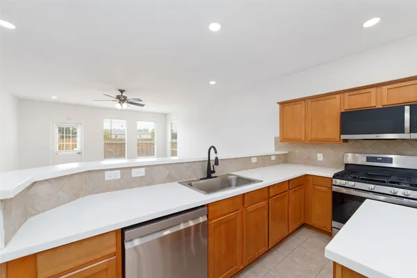 a kitchen with a sink stove and microwave