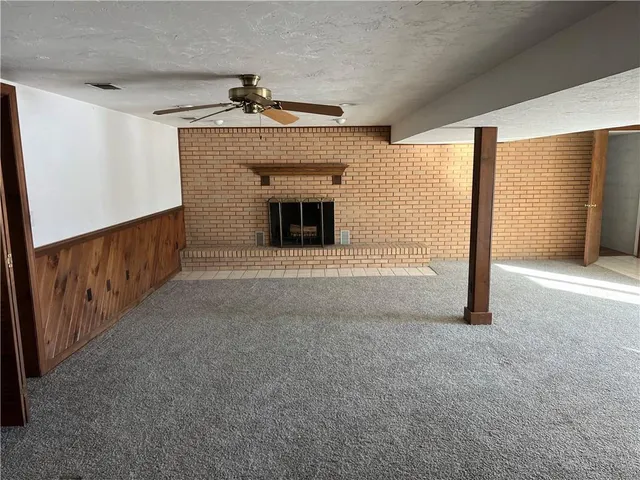 a view of an empty room with a fireplace