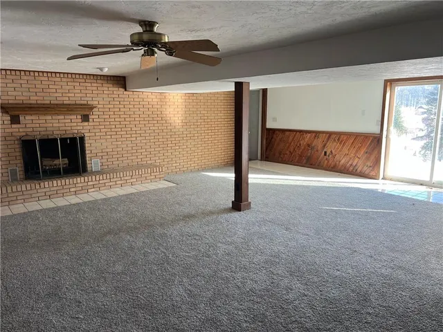 a view of an empty room with a fireplace