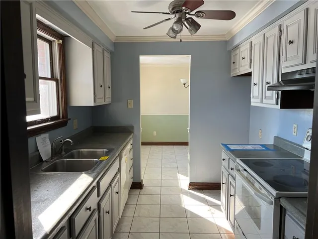 a kitchen with stainless steel appliances granite countertop a sink stove and cabinets