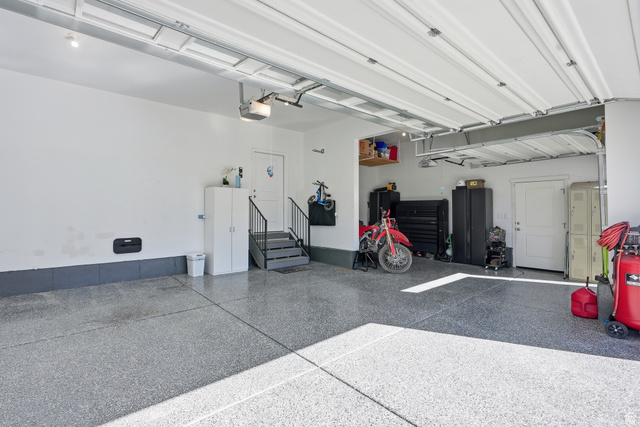 1202 South Raintree Lane Santaquin, UT 84655 - Photo 43 of 45 Spacious garage with epoxy flooring, white walls, and a finished ceiling