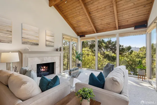 a view of a dining room with furniture and a potted plant