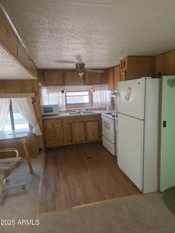 a kitchen with refrigerator and window