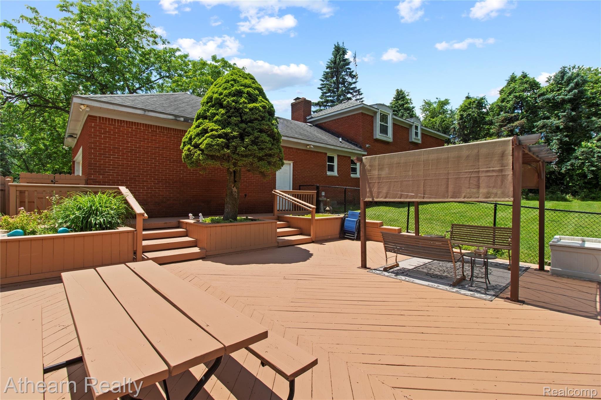 12427 Foley Road Fenton, MI 48430 - Photo 14 of 47 Expansive multi-level wood deck featuring a built-in planter, steps, and privacy railings
