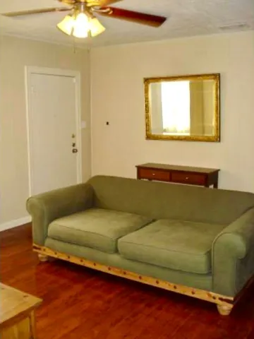 a living room with a couch and chandelier