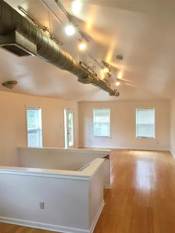 a view of a living room with kitchen