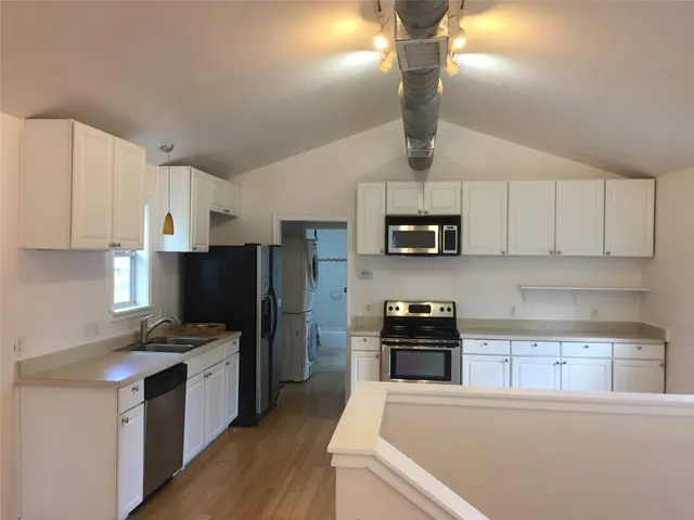 a kitchen with stainless steel appliances a refrigerator stove and microwave