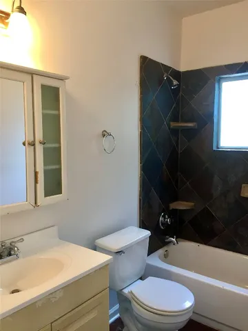 a bathroom with a toilet a sink and bathtub
