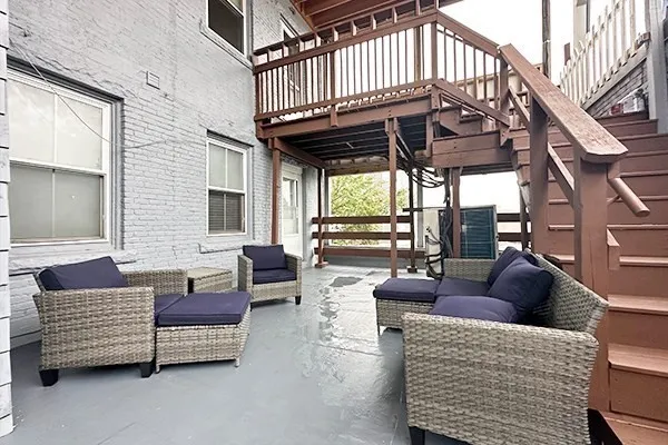 a outdoor living space with patio furniture and a fireplace