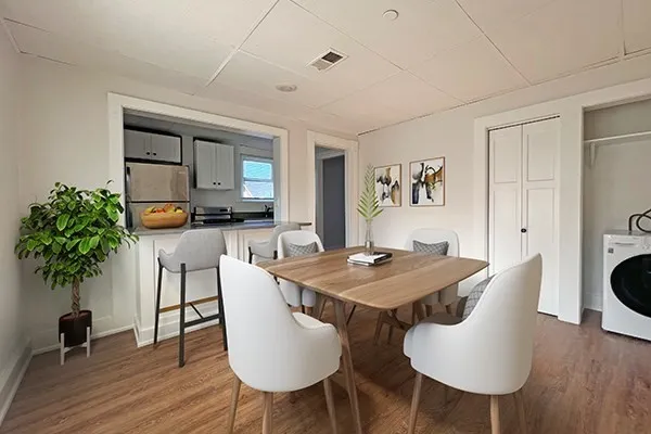 a view of a dining room with furniture and wooden floor