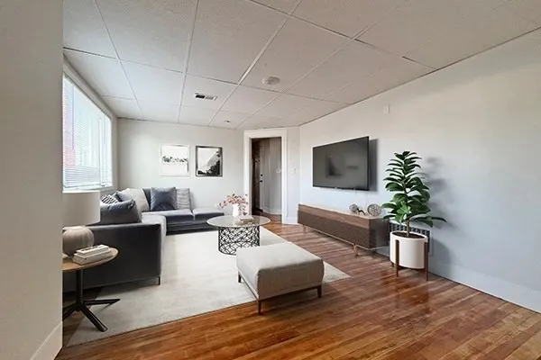 a living room with fireplace furniture and a flat screen tv