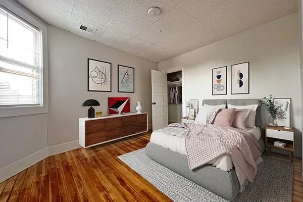 a bedroom with a bed and a couch