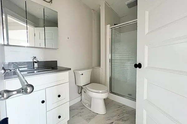 a bathroom with a sink toilet and shower