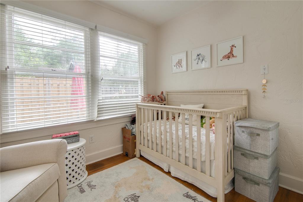 407 Northeast 8th Street Gainesville, FL 32601 - Photo 11 of 32 a bedroom with a bed and a window