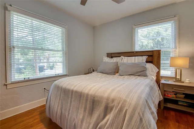 a bedroom with a bed and wooden floor