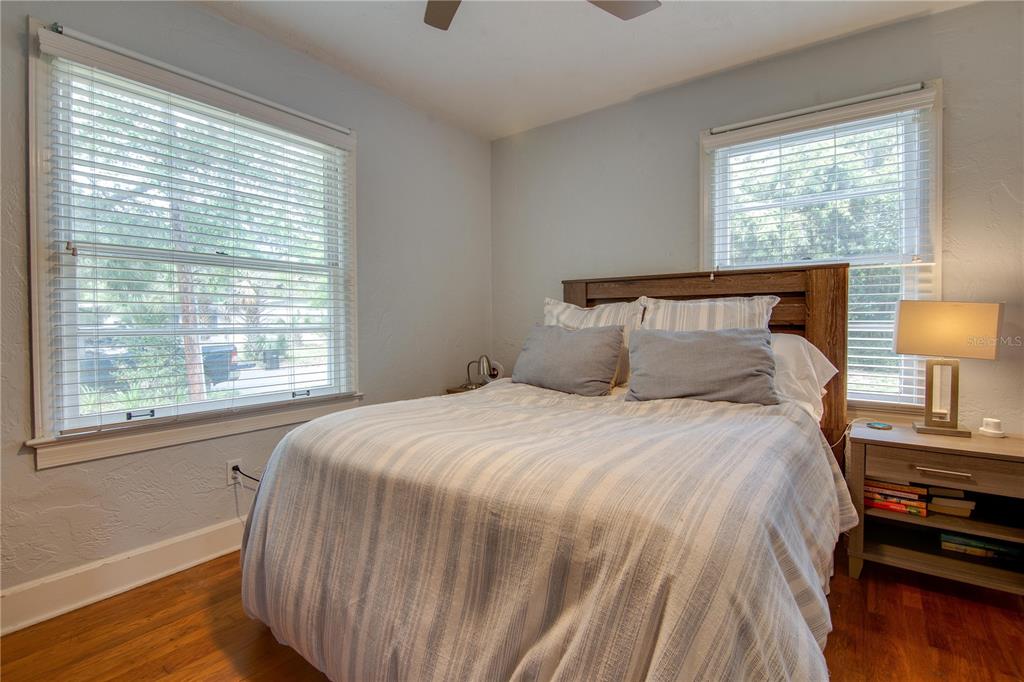 407 Northeast 8th Street Gainesville, FL 32601 - Photo 13 of 32 a bedroom with a bed and wooden floor