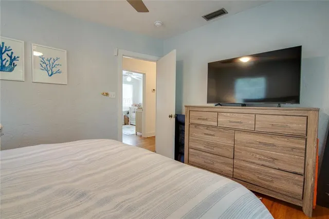 a bedroom with a bed and a flat screen tv