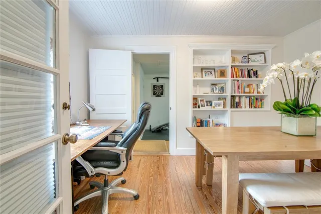 a view of a workspace with furniture and wooden floor