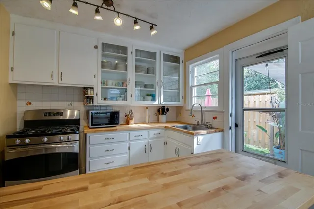 a kitchen with granite countertop a stove and a sink