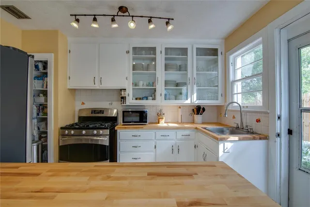 a kitchen with a stove a sink and a refrigerator