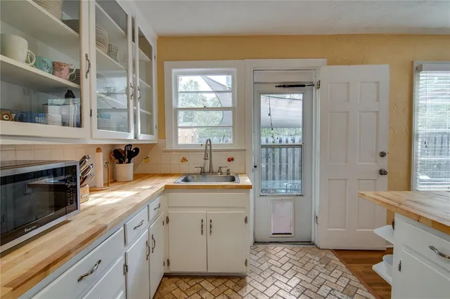 a kitchen with a sink stove and cabinets