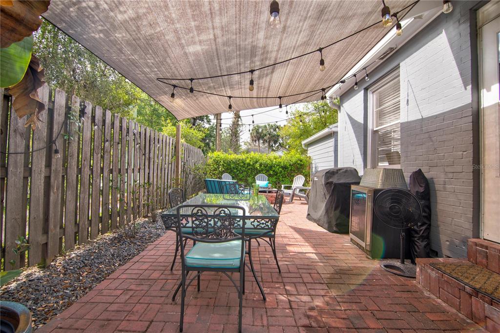 407 Northeast 8th Street Gainesville, FL 32601 - Photo 27 of 32 a patio with table and chairs and potted plants