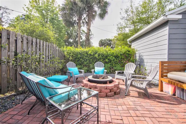 a view of a chairs and table in the back yard of the house