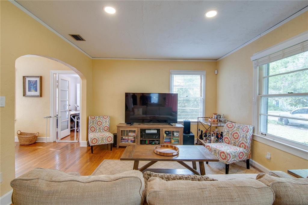 407 Northeast 8th Street Gainesville, FL 32601 - Photo 4 of 32 a living room with furniture and a flat screen tv
