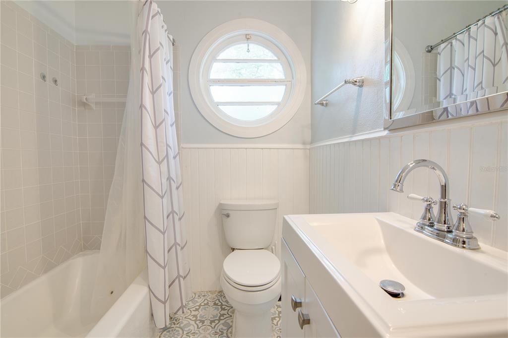 407 Northeast 8th Street Gainesville, FL 32601 - Photo 9 of 32 a bathroom with a sink a toilet and a mirror