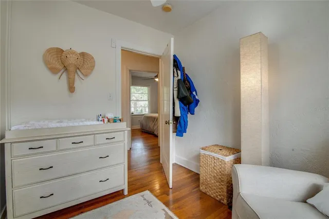 a living room with furniture and a mirror