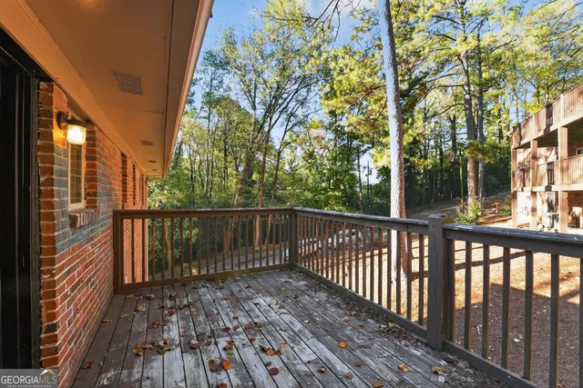 a view of balcony with wooden floor and fence