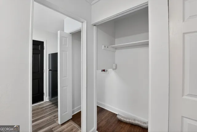 a view of a hallway with wooden floor