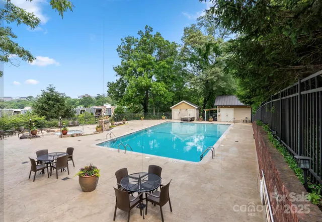a view of a backyard patio and swimming pool