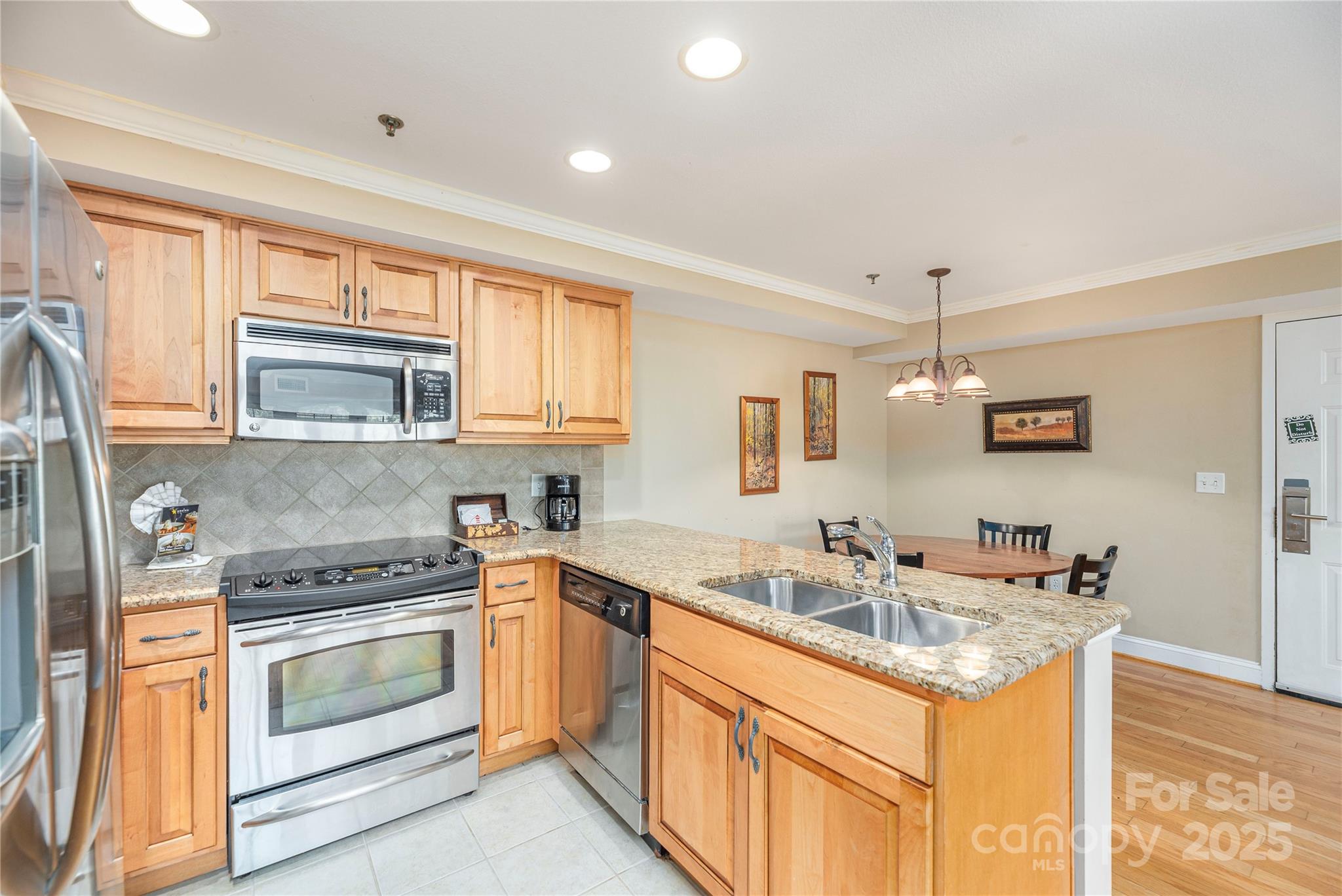 114 Bowling Park Road Asheville, NC 28803 - Photo 11 of 33 a kitchen with stainless steel appliances granite countertop a sink stove and refrigerator