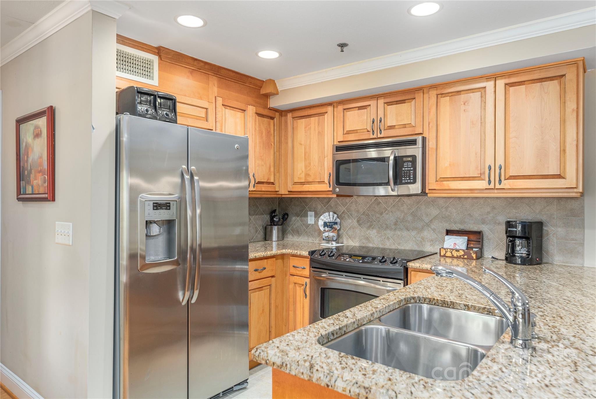 114 Bowling Park Road Asheville, NC 28803 - Photo 12 of 33 a kitchen with stainless steel appliances granite countertop a refrigerator a sink a stove with cabinets