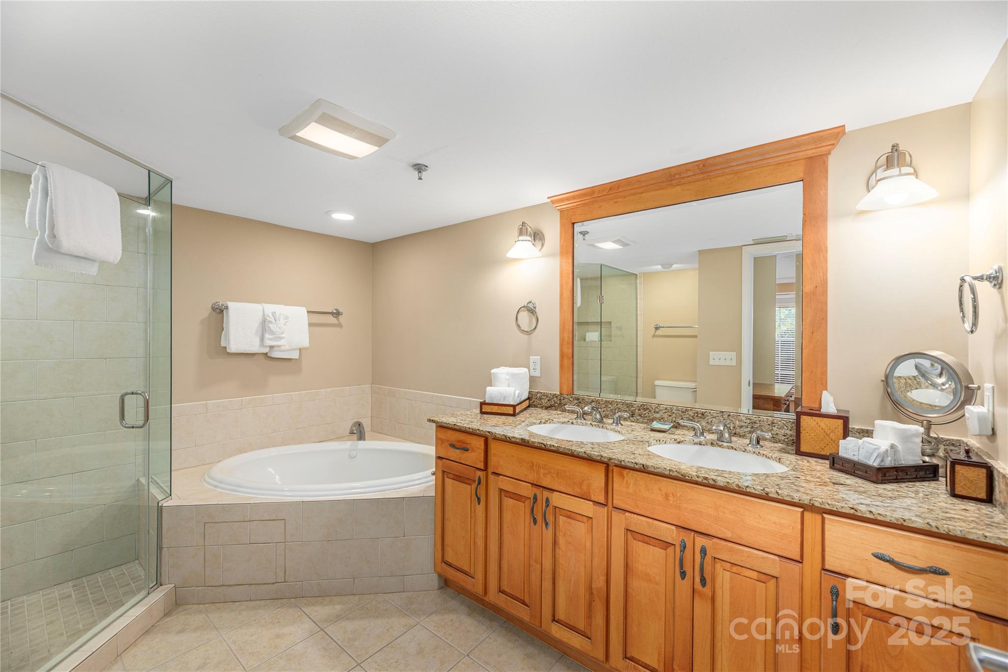 114 Bowling Park Road Asheville, NC 28803 - Photo 13 of 33 a spacious bathroom with a granite countertop sink mirror and shower