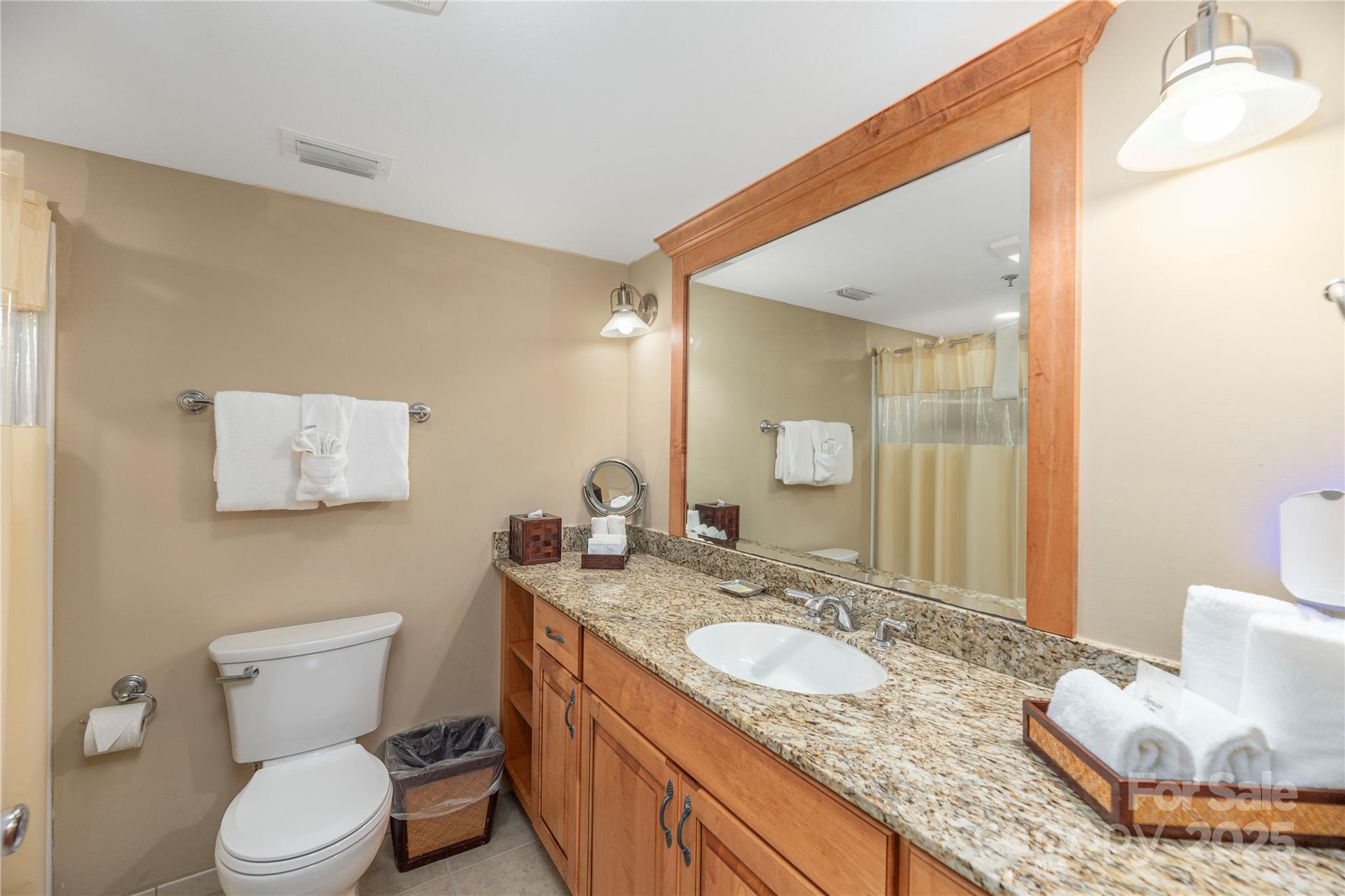 114 Bowling Park Road Asheville, NC 28803 - Photo 15 of 33 a bathroom with a granite countertop sink and a mirror