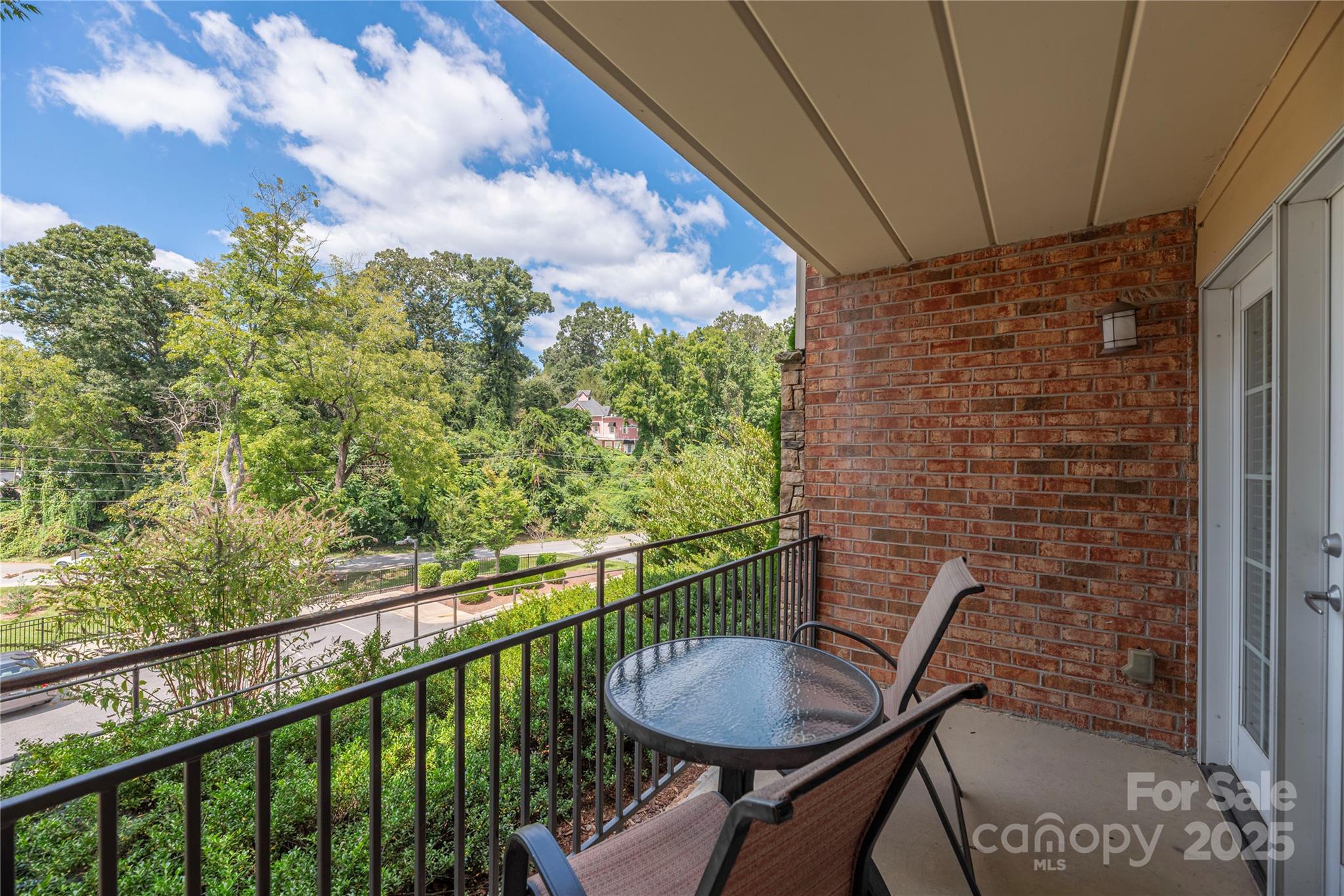 114 Bowling Park Road Asheville, NC 28803 - Photo 3 of 33 a view of a balcony with table and chairs and wooden fence